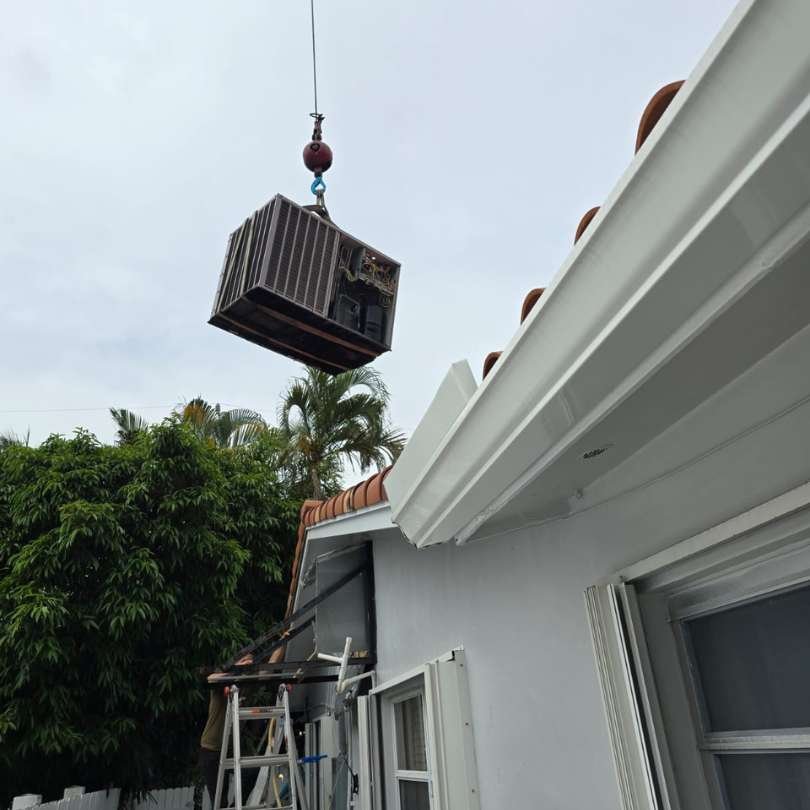 Heavy-duty HVAC unit being lifted for residential AC installation in South Florida by Colder of Miami.