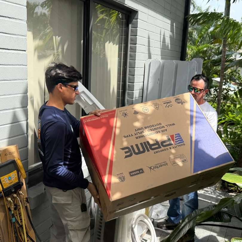 Colder of Miami technicians delivering and preparing an AC unit for residential repair servic