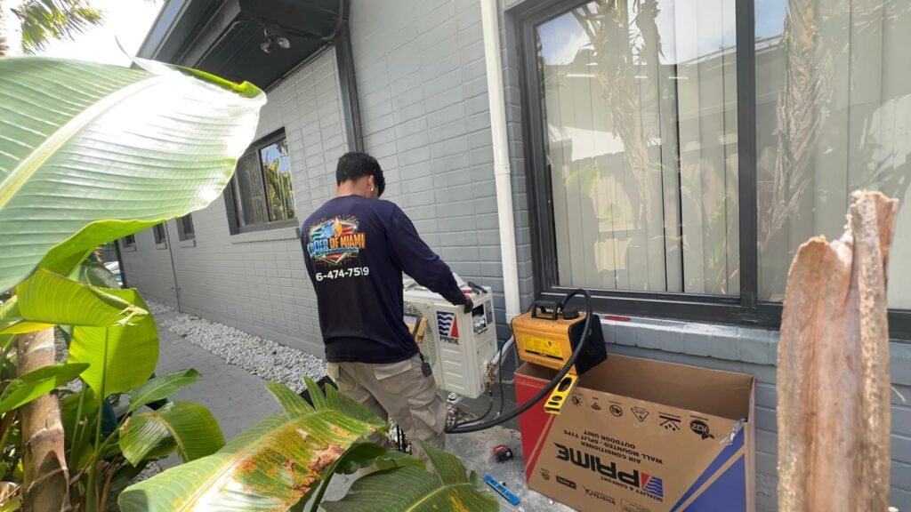 Colder of Miami uniformed technician charging an AC unit on an emergency call in Miami