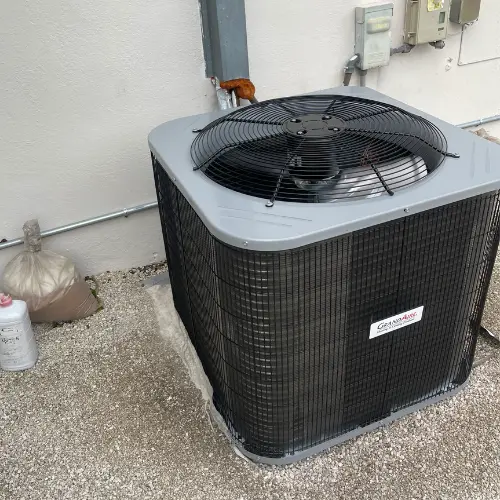 A GrandAire outdoor air conditioning condenser unit installed next to a residential wall during an emergency AC repair service in Hallandale Beach.